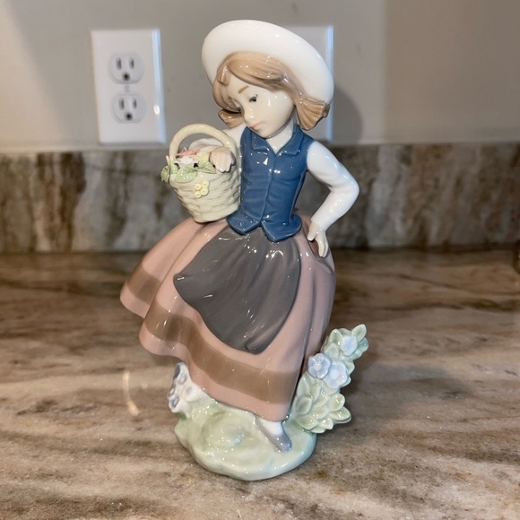 Lladro sweet scent girl holding basket of flowers